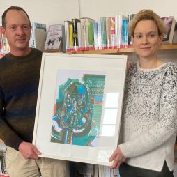 Sonja Hohnholt, Leiterin der Stadtbibliothek Aurich, und Welf-Gerrit Otto, Leiter der Kulturagentur der Ostfriesischen Landschaft, präsentieren das erste Bild der Wechselausstellung (Foto: Stadtbibliothek Aurich)